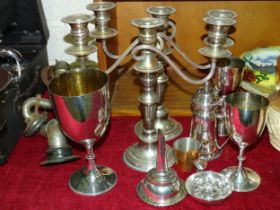 A pair of plate three-light candelabra, 27.5cm high, a plated wine funnel and other plated ware.