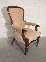 A Victorian mahogany button-back salon chair with partially-upholstered carved arms, on serpentine