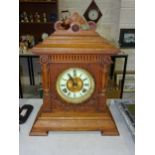 An Ansonia Clock Co. oak-cased clock of architectural design striking on a gong, with paper label '