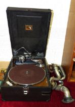 An HMV portable wind-up gramophone, together with two spare sound boxes, etc.