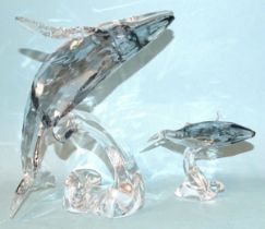 A Swarovski Crystal Society Twenty-Five Years Sculpture Paikea Whale 2012 and a Paikea calf, both in