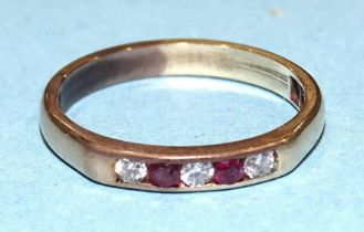 A gold ring channel-set two rubies and three diamonds, unmarked, tests as 14ct approximately, size