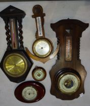 A collection of 20th century aneroid barometers, some damaged.