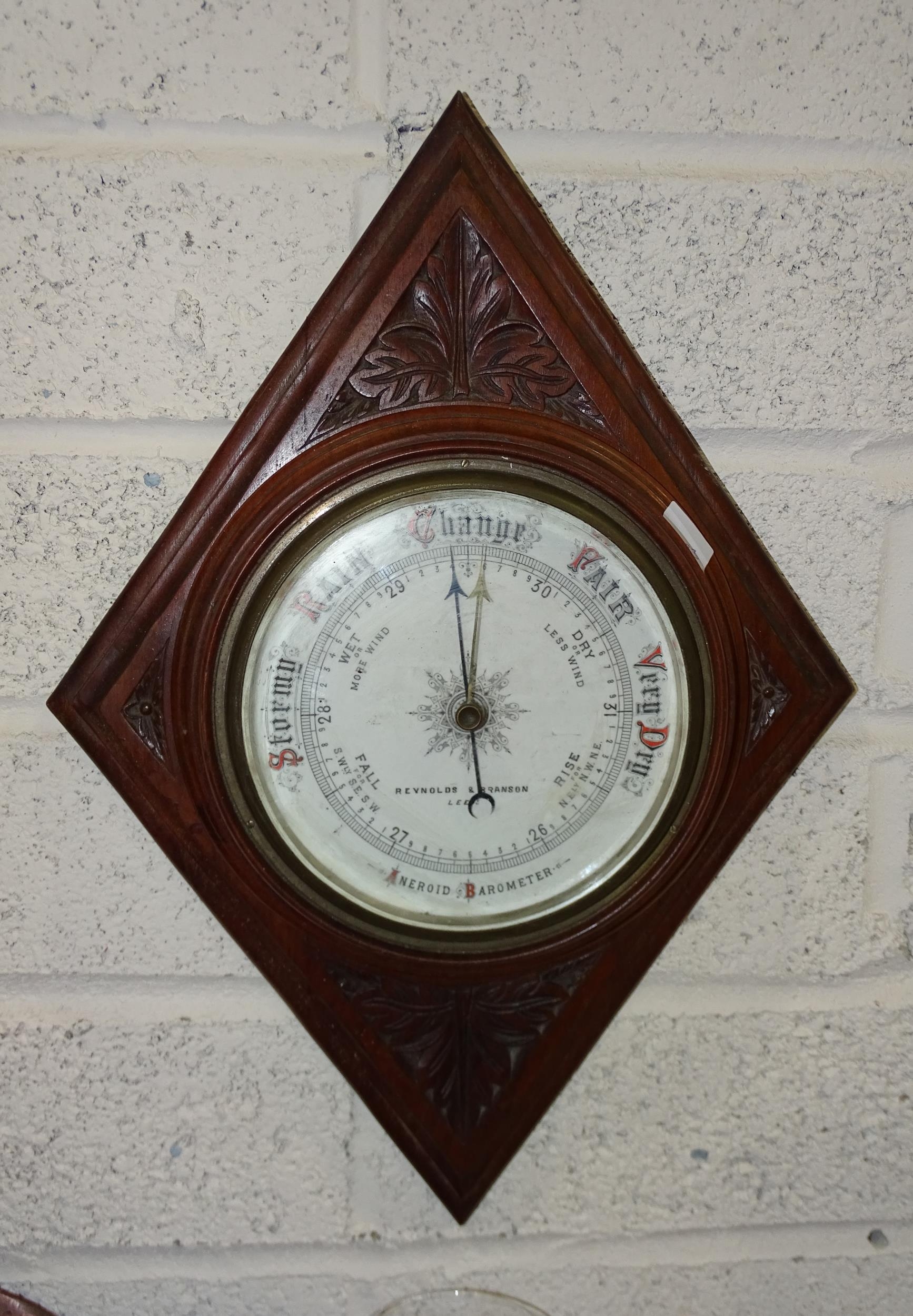 Reynolds & Branson, Leeds, a mahogany framed circular aneroid barometer on diamond-shape plaque