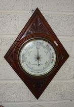 Reynolds & Branson, Leeds, a mahogany framed circular aneroid barometer on diamond-shape plaque