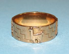 A gold ring with raised Inca symbols, size U, marked '18k', 10.3g.