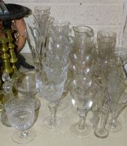 A collection of various drinking glasses, including champagne flutes, wine glasses, laboratory glass