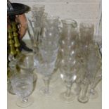 A collection of various drinking glasses, including champagne flutes, wine glasses, laboratory glass