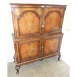 A walnut four-door drinks cabinet, 102cm wide, 150cm high.