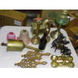 A pair of brass covered iron door stops, a pair of brass trivets, a brass clockwork rotisserie/