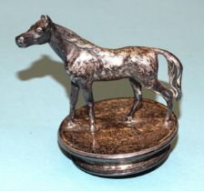 A small plated car mascot in the form of a horse, 7.5cm high, base 6cm diameter.