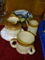 A 19th century partially glazed stoneware three-handled loving cup decorated with a coat of arms,