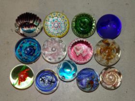 A collection of thirteen glass paperweights, including three by Caithness: 'Sea Pearls', '