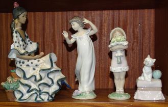 A collection of four Lladro figurines: 'Andalusian Dancer' 2170, 'Young girl holding flowers'