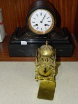 A black slate mantel clock, the drum movement marked H, striking on a bell, 23.5cm high, 29cm