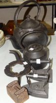 A cast iron kettle marked '12', 35cm, a similar smaller kettle marked 35/8, 24cm, two flat irons,