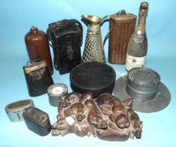 A large pewter inkwell and quill stand, a copper hot water bottle, a cow bell, leather instrument