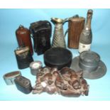 A large pewter inkwell and quill stand, a copper hot water bottle, a cow bell, leather instrument