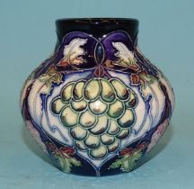 A small modern Moorcroft ceramic pot of baluster shape, line-decorated with grapes and vines,