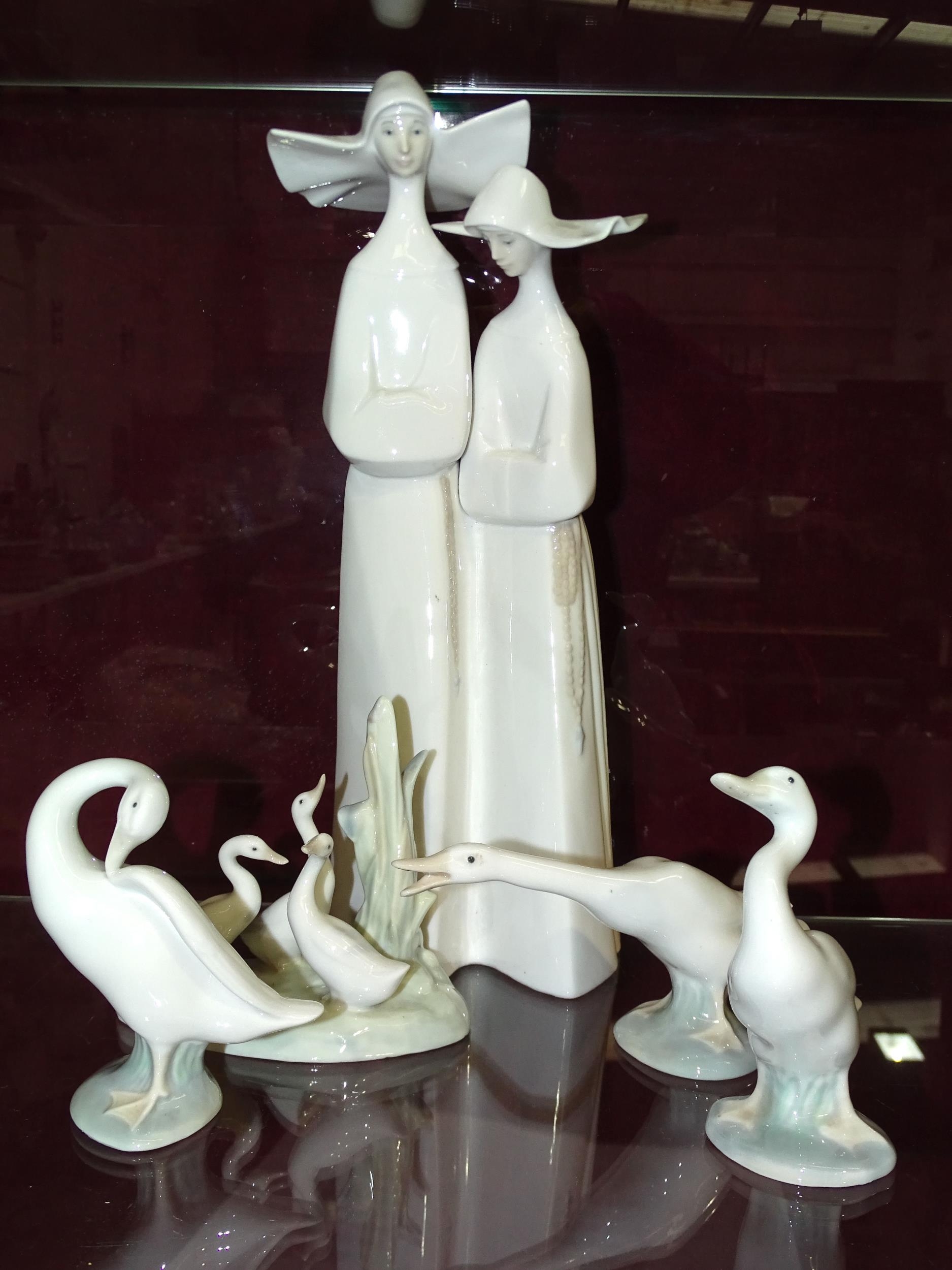 Lladro, a figurine depicting two nuns in habits, Lladro back stamp and impressed marks to base, 34cm - Image 5 of 5