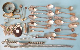 A small quantity of silver cutlery, ___5.3oz, a silver identity bracelet, silver rings and other