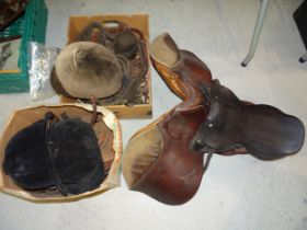 A leather saddle, bridle and other riding accessories.