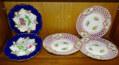 A pair of 19th century cabinet plates, each centrally-painted with flowers within a deep blue and