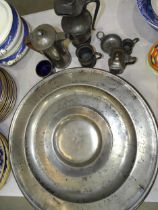 Two large pewter chargers with London touch marks, 52cm diameter, three smaller dishes and other
