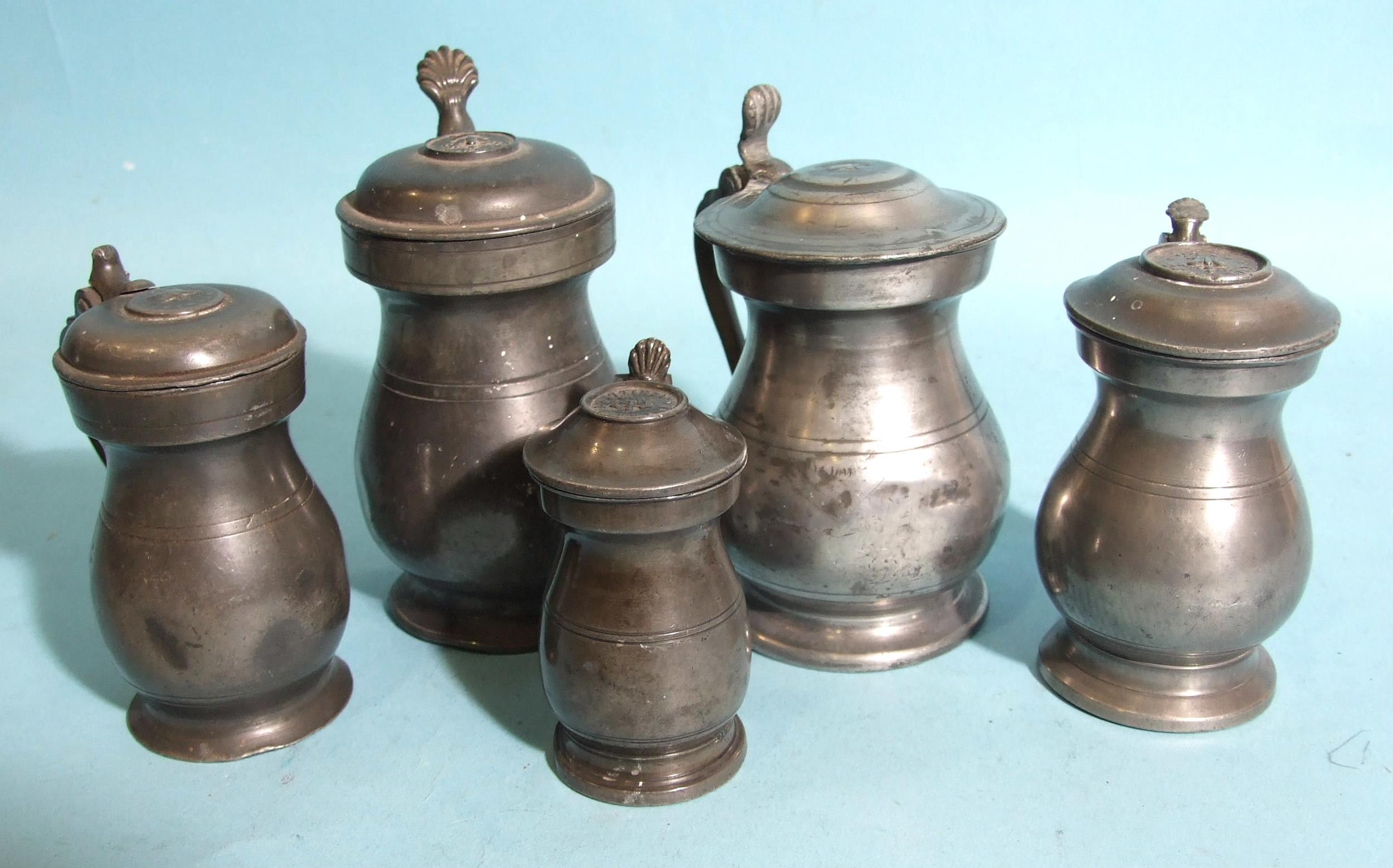 A collection of Scottish pewter imperial baluster measures with hinged lids: ½-Pint, Gill (x2), ½-