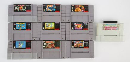 An assortment of loose NTSC Super Nintendo (SNES) game cartridges (x9) + Universal Adapter