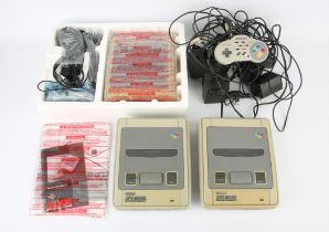 A boxed Super Nintendo System (SNES) + a selection of loose accessories and cables for Super