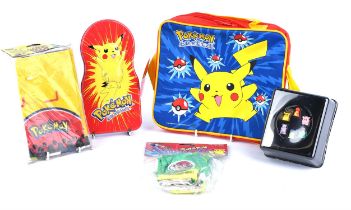 Assortment of Pokemon Merchandise including a bag, playmat, gloves, tin and monopoly figures.