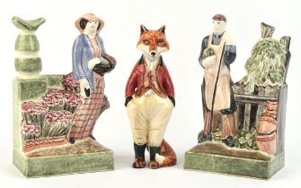 Rye Pottery, a pair of pottery bookends, moulded in the form of a gentleman and lady gardener,