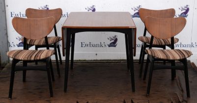 A G-plan teak drop leaf dining table and four chairs, on ebonised supports, bearing G-Plan stencils,