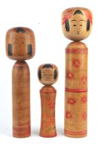 Three Kokeshi of typical form, from the Tohoku tradition of Northern Honshu; the tallest about 55