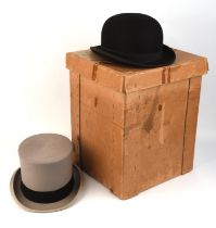 A gentleman's black bowler hat and a grey felt top hat both size 7 1/8 (Large) Boxed. 2 items