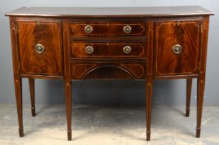 A George III style mahogany sideboard, inlaid with stringing, the three central drawers enclosed by