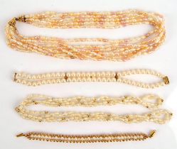 A collection of pearl items, including a multi strand freshwater pearl necklace with cream pearls