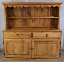 Large pine dresser, with a row of pot hooks, above a single shelf, the base with frieze drawers