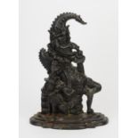 A cast iron doorstop in the figure of Mr Punch, early 20th century, bearing cast medallion for
