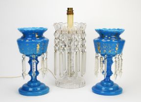 A pair of late Victorian opaque blue glass lustres, gilt decorated, of baluster form and on domed