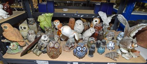 A large group of owls, in various mediums, some modelled as money boxes, including two examples by