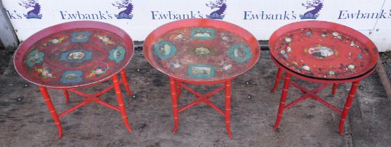 Two Continental red painted tole trays, early 20th century, on later faux bamboo stands,
