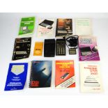 A Hewlett Packard HP-80 calculator and an assortment of vintage computing instruction manuals