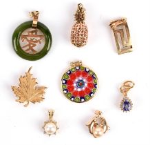 A selection of pendants including a jade pendant with symbol to the centre, a pineapple,