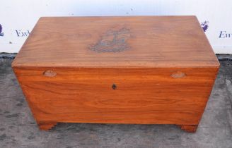 A Chinese camphorwood chest, the hinged lid with a carved galleon, the sides with handles, H 60cm,