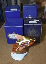 A group of five Royal Crown Derby porcelain paperweights, all boxed, to include a snake with silver