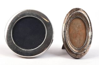 Two silver photo frames, one of oval form one in round form