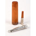 9ct Gold rimmed amber cheroot holder and an amber silver cheroot holder and silver case.