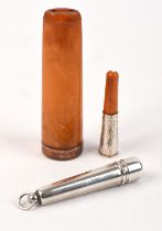 9ct Gold rimmed amber cheroot holder and an amber silver cheroot holder and silver case.